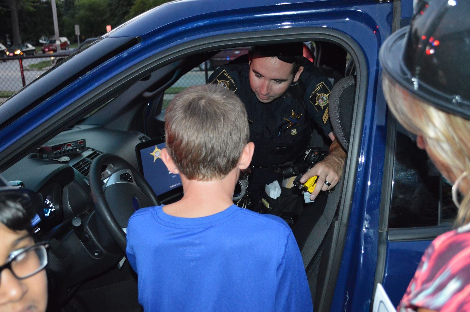 Families gather around a DuPage County Sheriff's vehicle during a National Night Out event at the Iowa Community Center, Aug. 2.